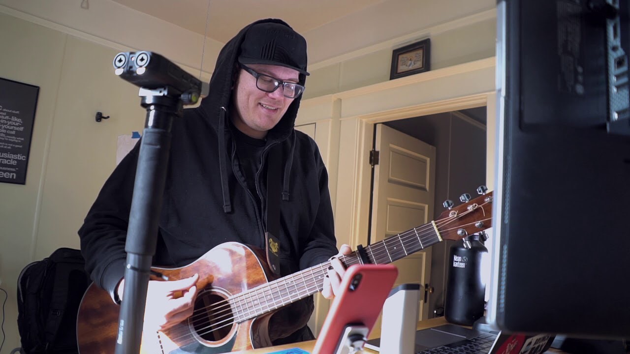 me recording a song with an acoustic guitar and lots of microphones and computer junnk obscuring the frame